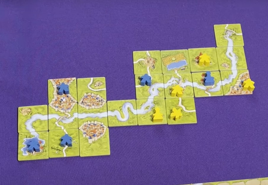 classic Carcassone map with city, road and river tiles; colorful pieces of meeples