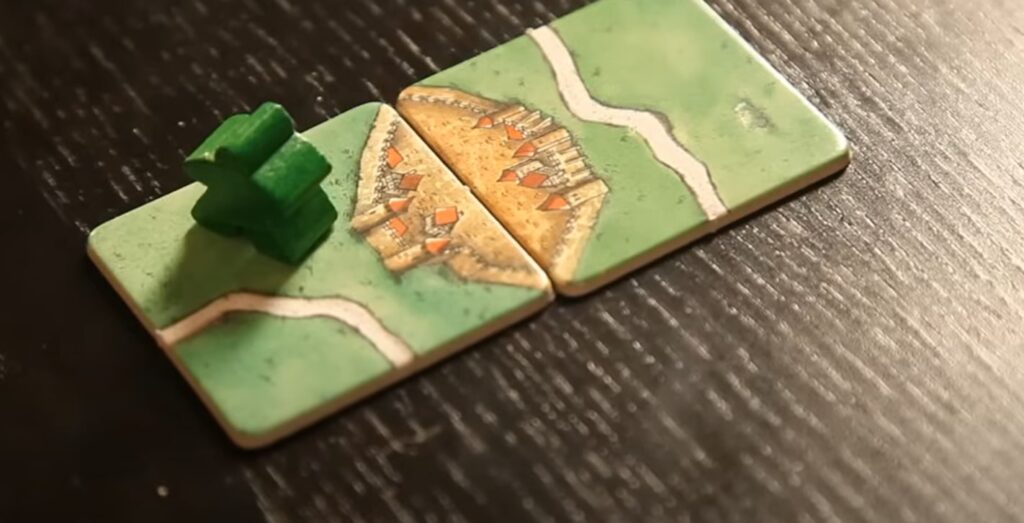 classic Carcassonne meeple piece standing on the town tile