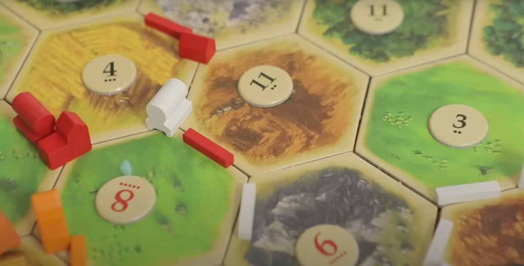 building-pieces and different tiles on the Settlers of Catan map