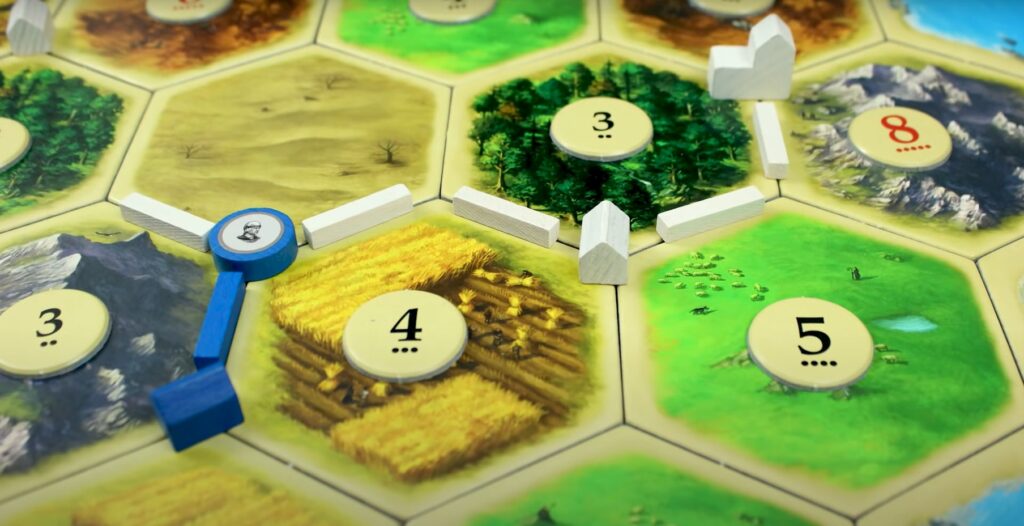 pieces and tiles from Catan's Cities and Knights expansion